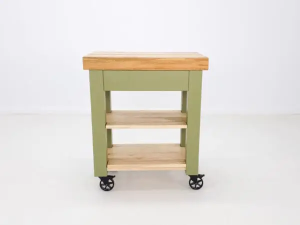 Green kitchen cart with wood top and shelves.