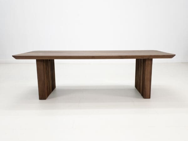 A walnut coffee table with ribbed legs.