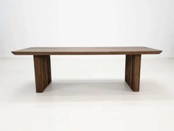 A walnut coffee table with ribbed legs.