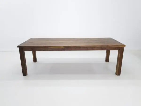 A parsons style walnut dining table.