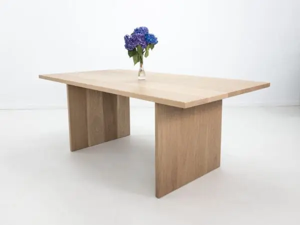 A white oak LILY dining table with a 1.5" thick table top.