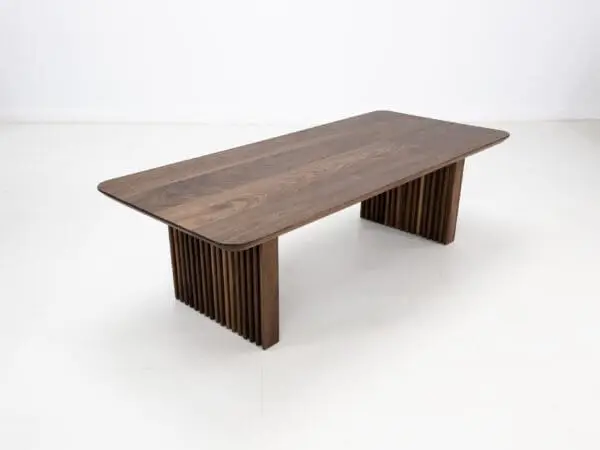 A walnut coffee table with ribbed legs.