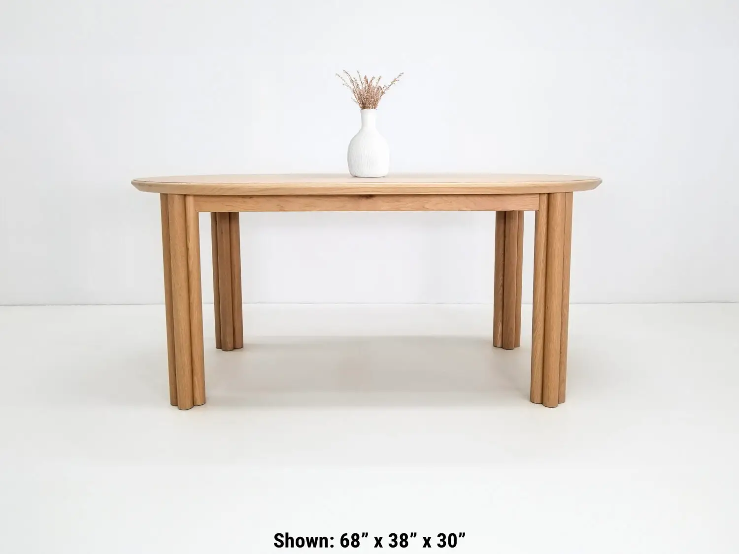 BEAU dining table in natural white oak with a 1⅜ inch thick oval top and clustered cylinder legs