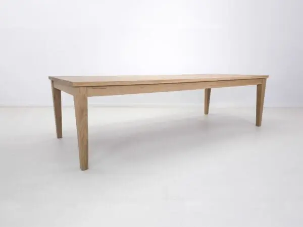 Wooden dining table with tapered legs.