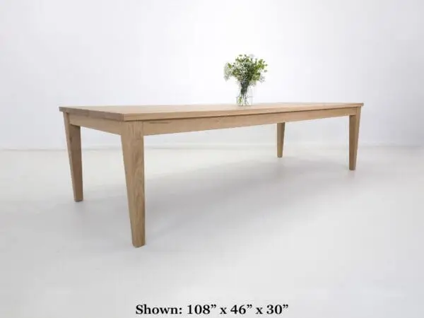 Wooden dining table with tapered legs.