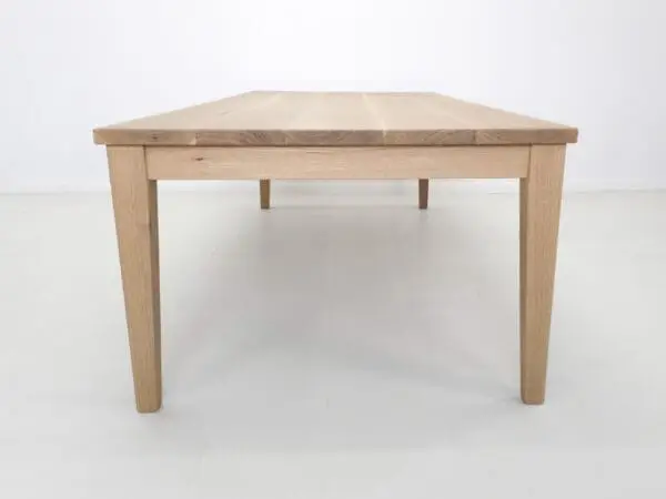 Light wood dining table with tapered legs.