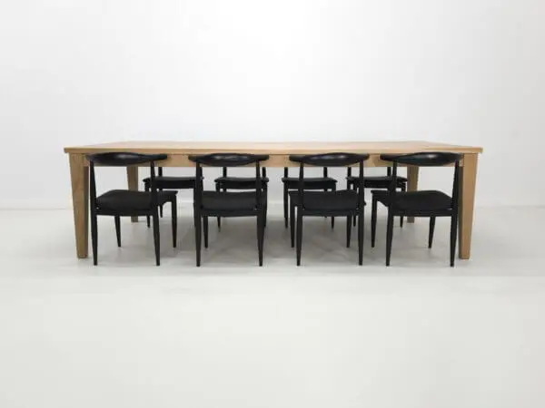 Wooden table with black chairs