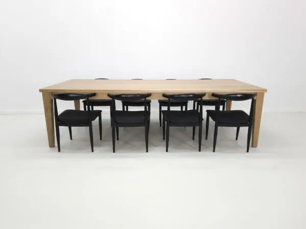 Wooden dining table with black chairs.