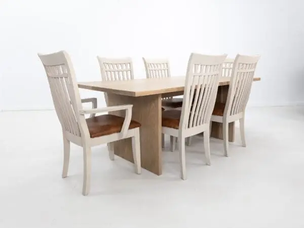 A white oak LILY dining table with a 1.5" thick table top and chairs around it.