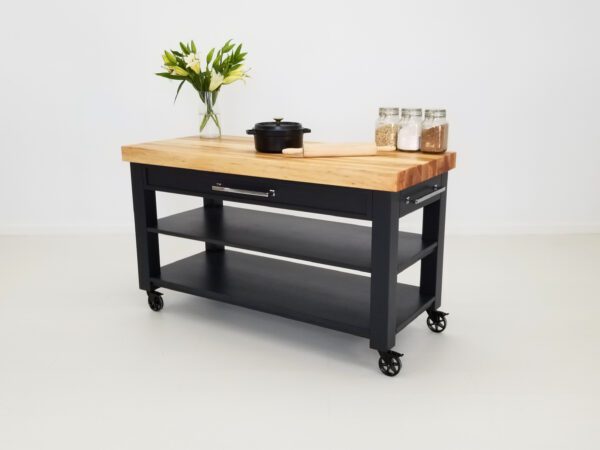 Our LUCA butcher block cart with flowers and kitchen utensils on top of it.