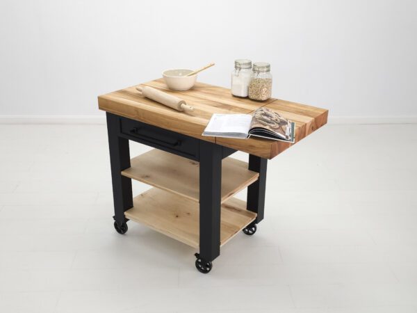 A butcher block cart with a drop leaf extension and baking items on top of it.