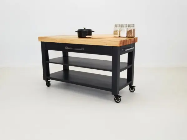 Our LUCA butcher block cart with flowers and kitchen utensils on top of it.