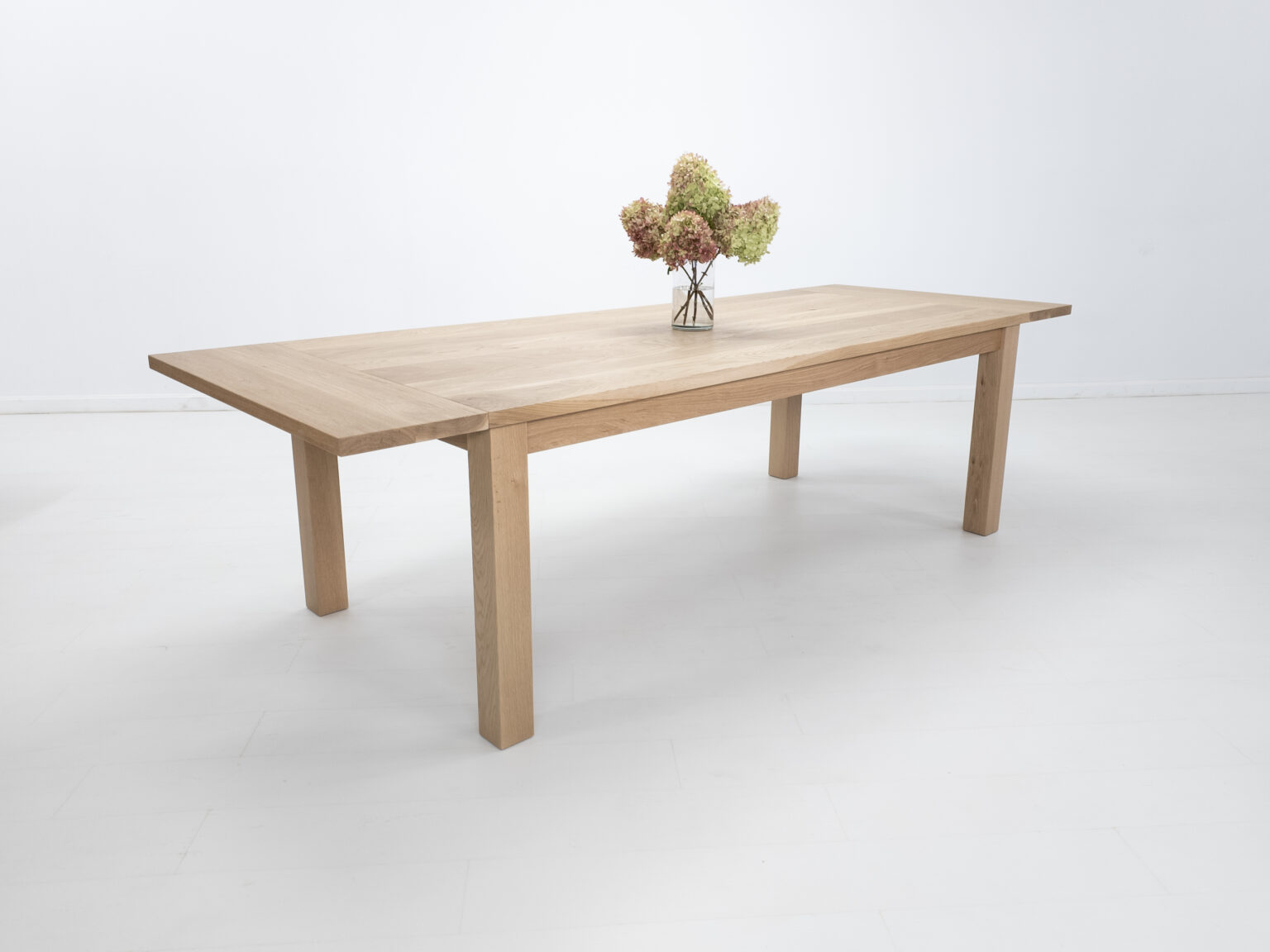 Oak extending dining table with flowers