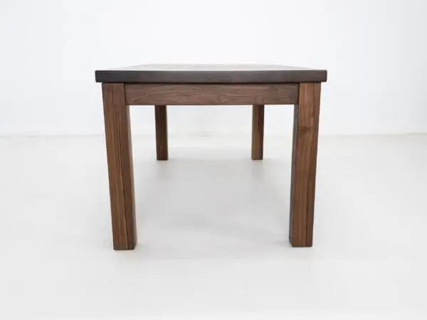 A parsons style walnut dining table.