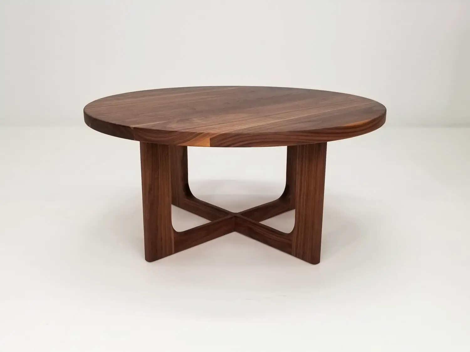 CARY coffee table in solid American hardwood with a 1⅜ inch thick round tabletop and open cross leg base