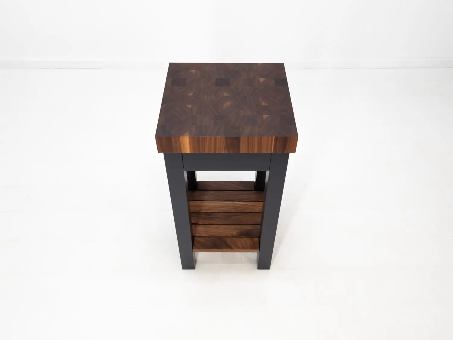 Overhead view showing patterned end grain walnut butcher block top