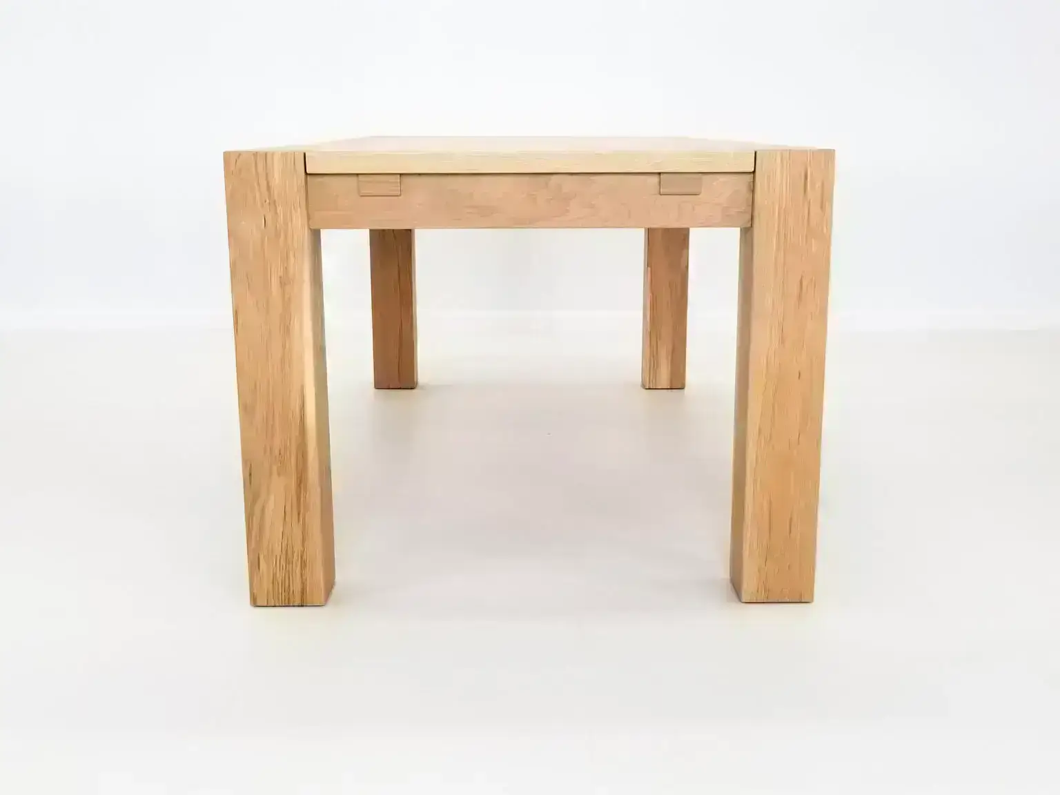 JAQI dining table handcrafted in natural white oak with seamless top and breadboard ends