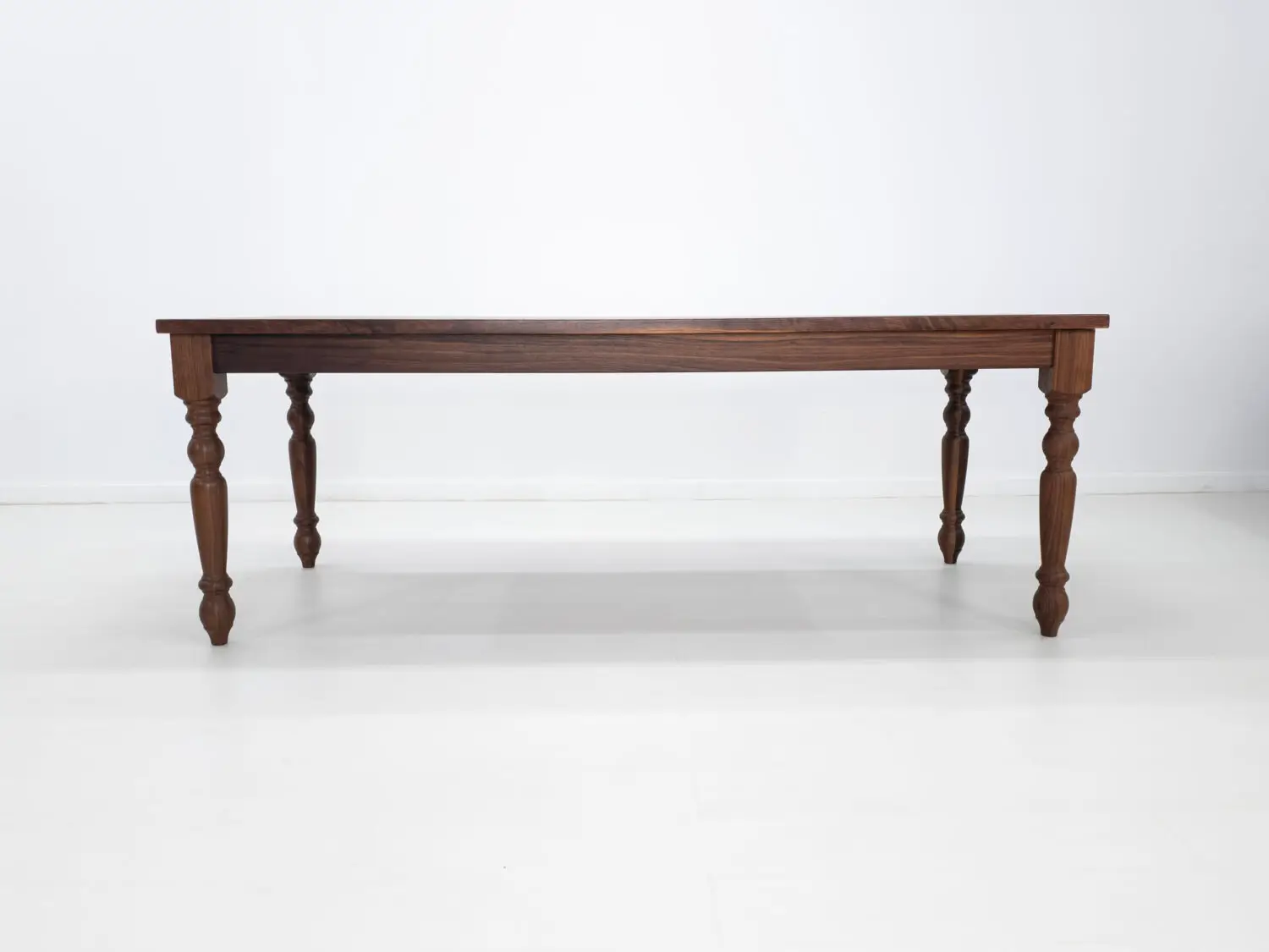 Traditional farmhouse style TESS table with turned legs designed to be a timeless centerpiece in any dining space