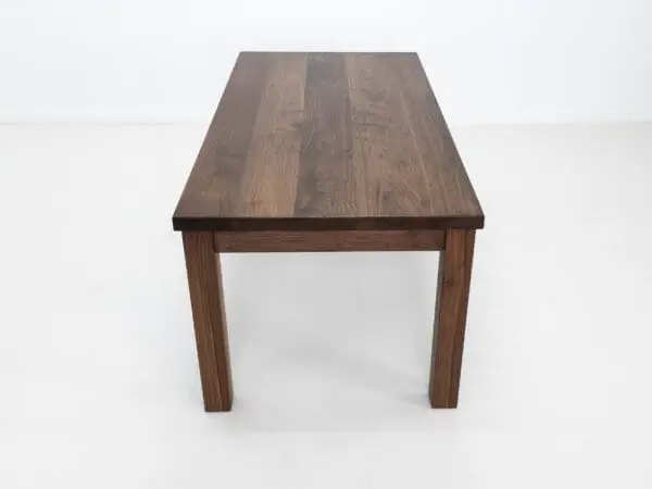 A parsons style walnut dining table.