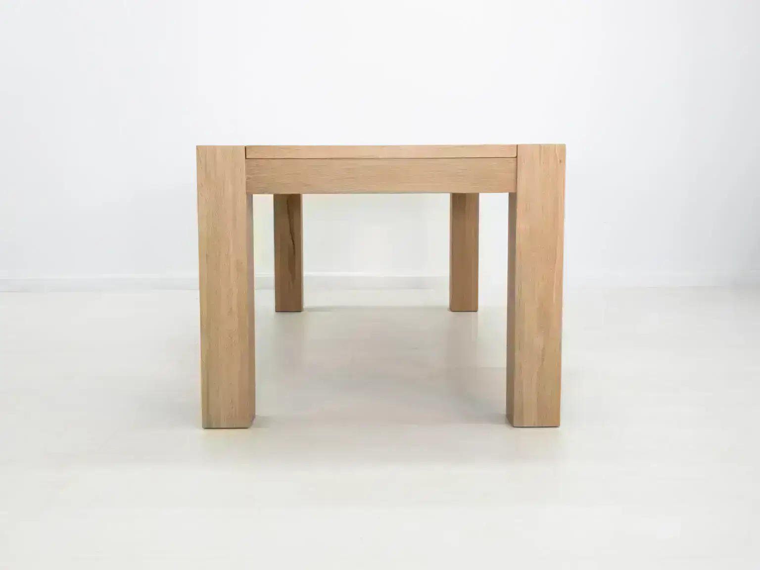 Elegant JAQI dining table in seawashed white oak perfect for modern or coastal interiors