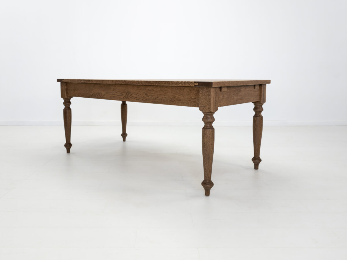 Handcrafted farmhouse table with turned legs and two drawers made from solid American hardwoods