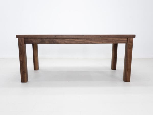 A parsons style walnut dining table.