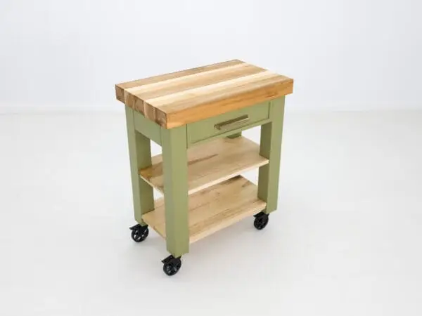 Green kitchen cart with wood top and shelves.