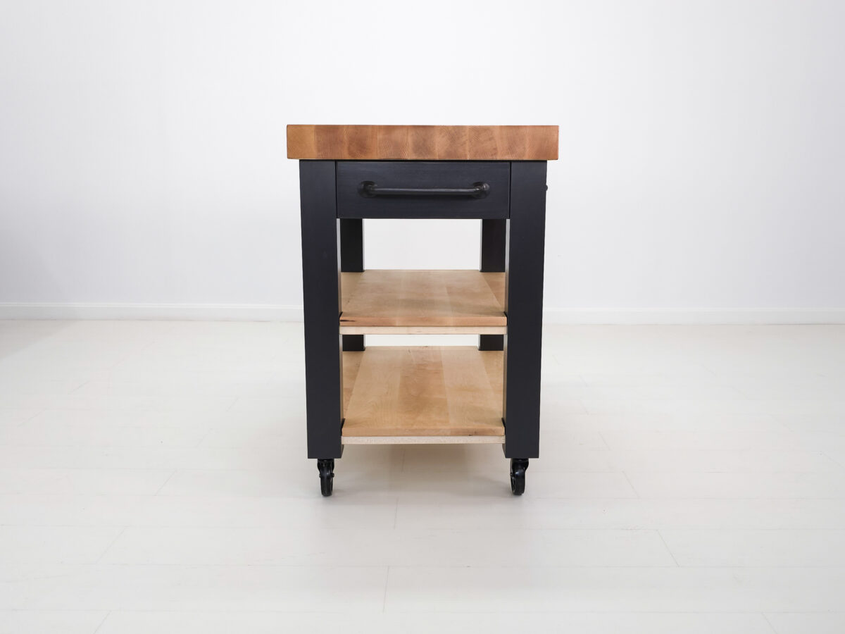 Black kitchen island with wooden top