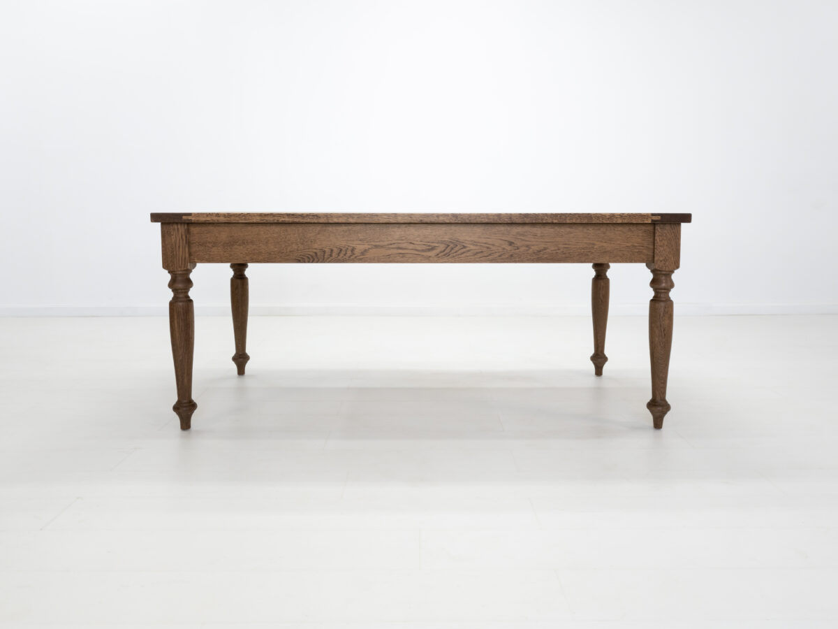 Handcrafted farmhouse table with turned legs and two drawers made from solid American hardwoods