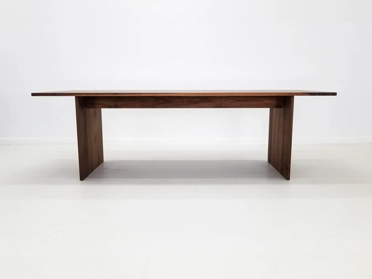 Walnut LILY dining table with a rich hardwax oil finish enhancing the deep brown tones