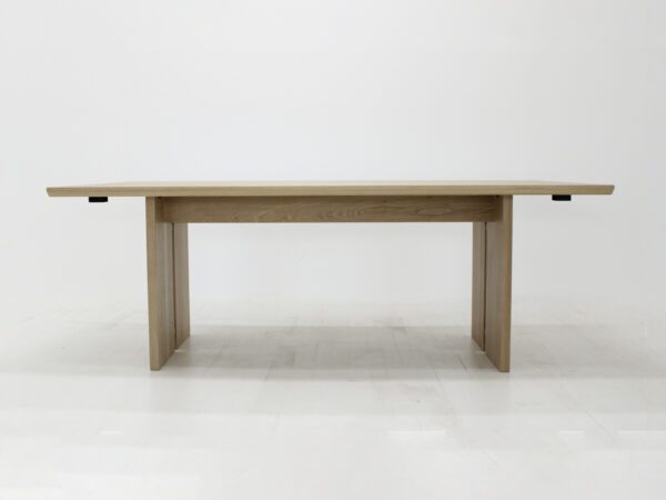 A panel table with split legs.