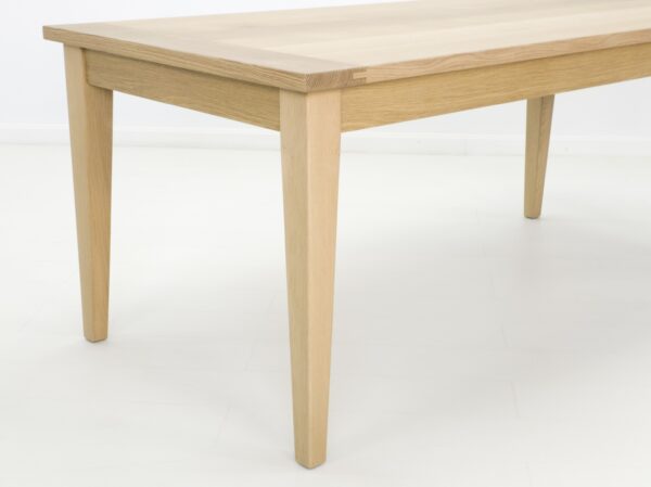 A close up of the tapered legs on this dining table.