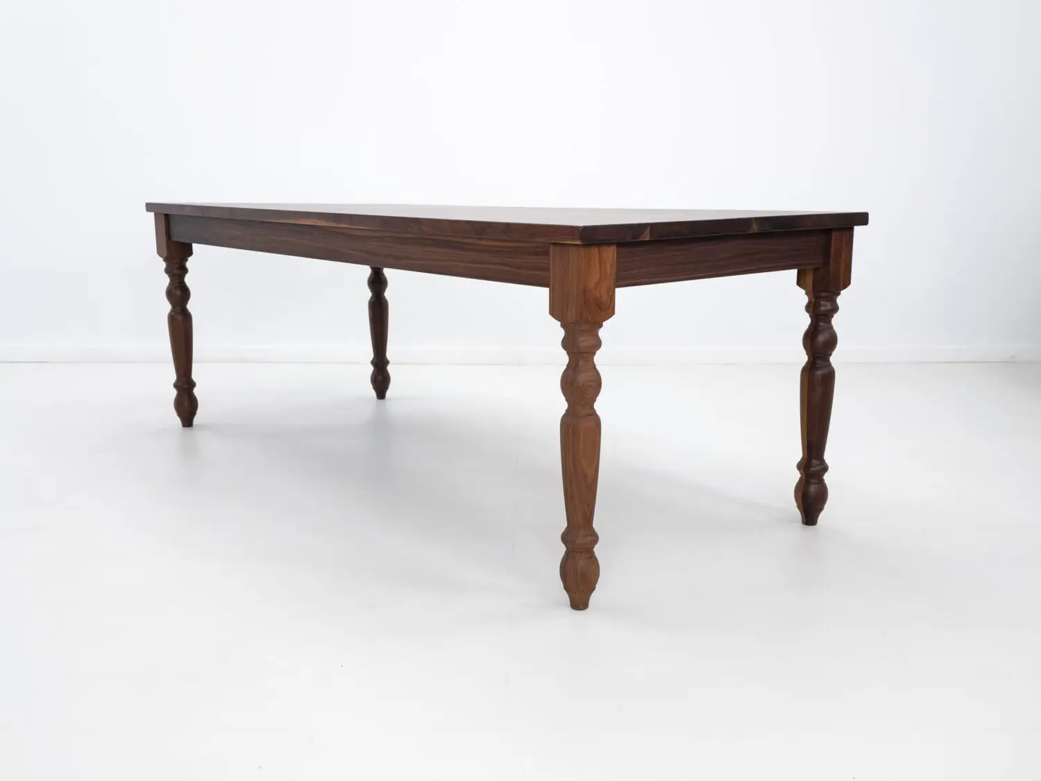 Traditional farmhouse style TESS table with turned legs designed to be a timeless centerpiece in any dining space
