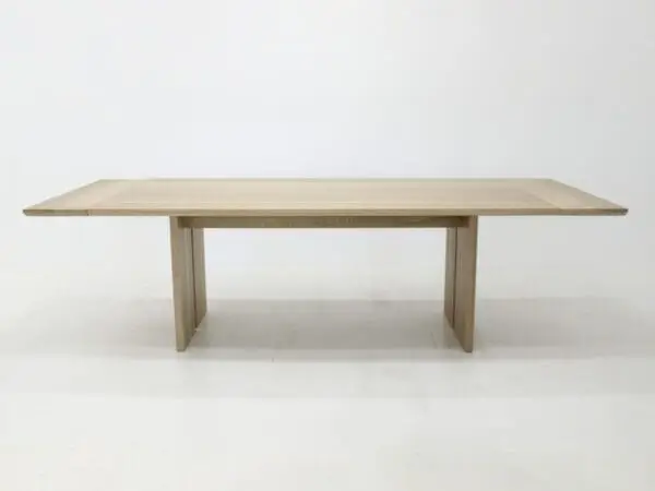 A panel table with split legs and extensions.