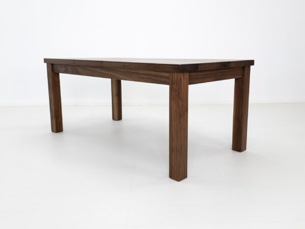 A parsons style walnut dining table.