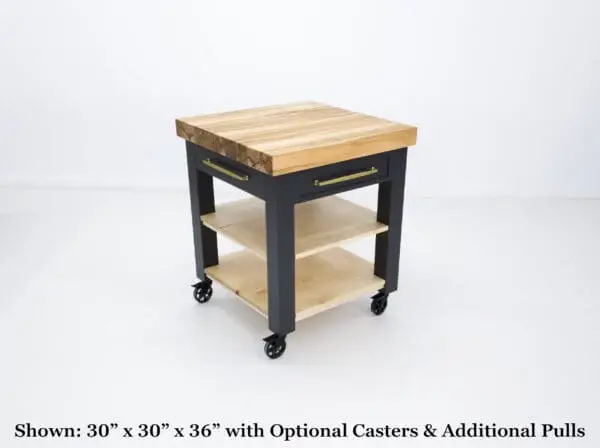 Black kitchen island with wood top and casters.