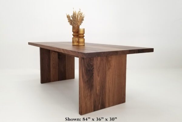 A walnut dining table with vases on top of it.