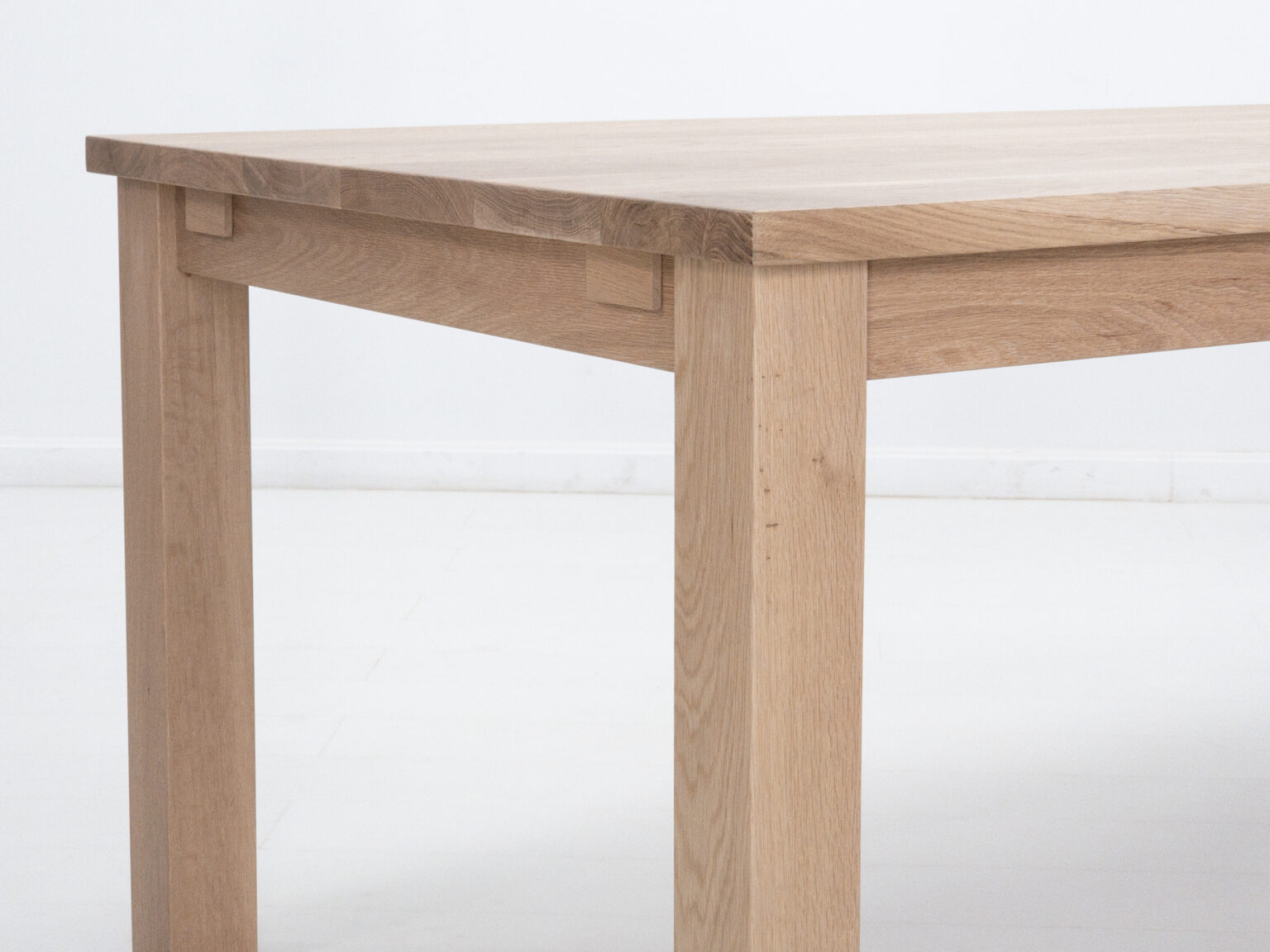 Light oak wood dining table corner