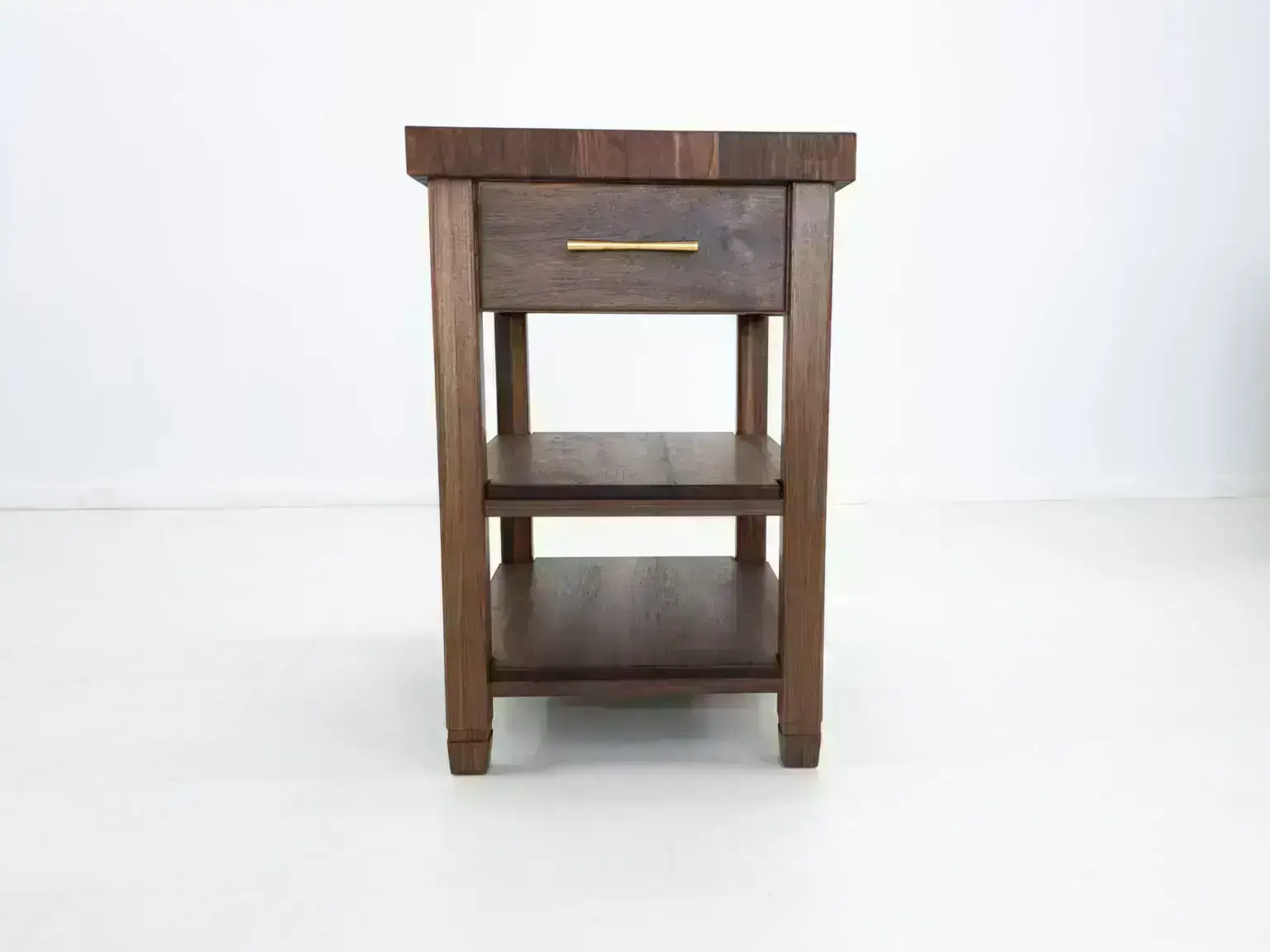 Dark wood side table with drawer and shelves