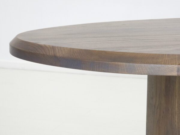 A close up of the edge of a freeform dining table.