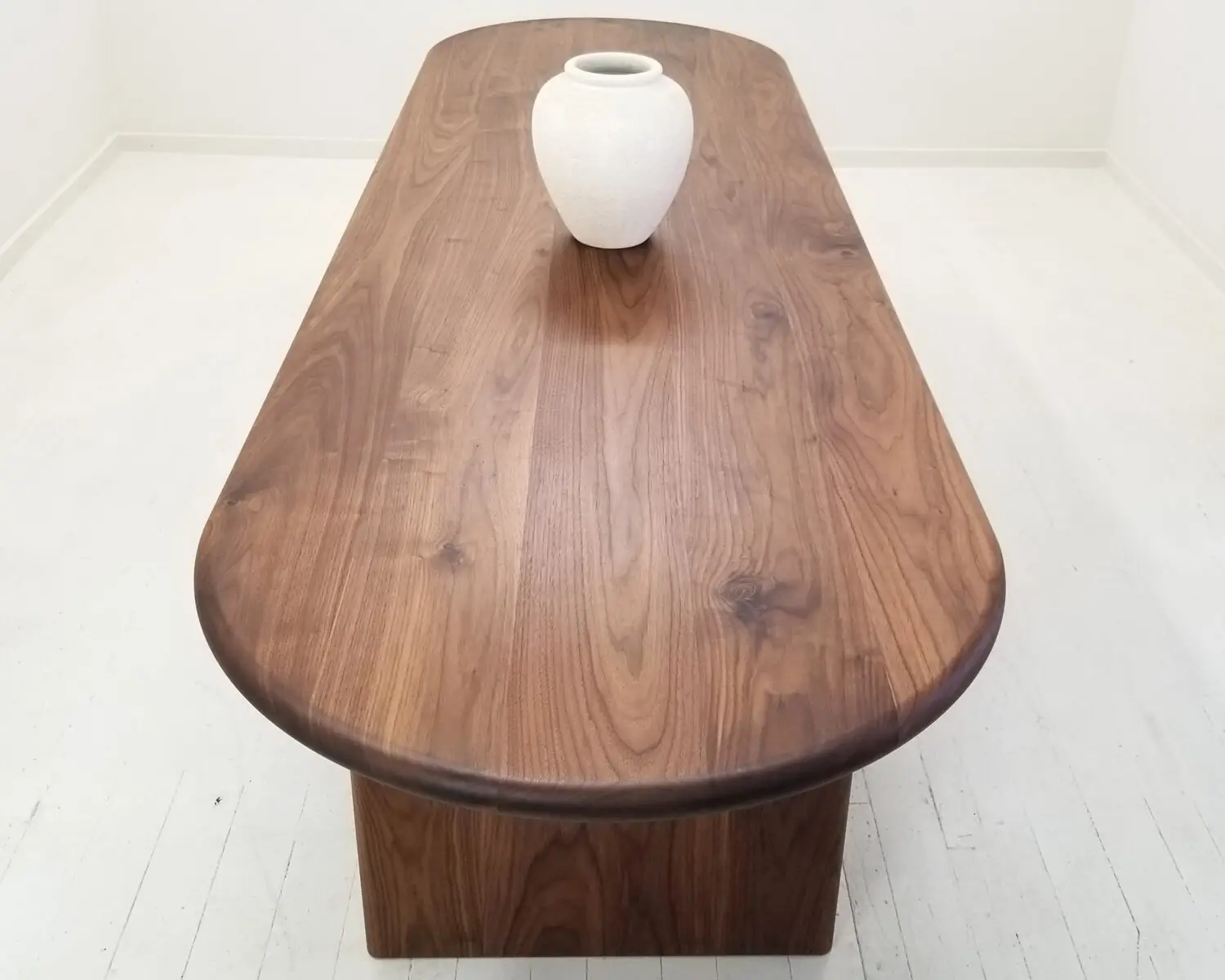 Close up of the solid walnut tabletop  Displaying the rich grain and smooth hand finished surface