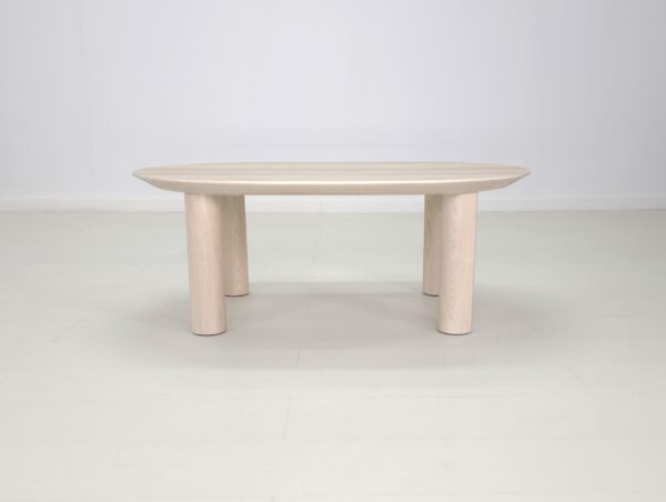 A white COVE coffee table with a wooden top and legs.