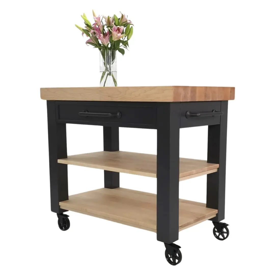 A CHEF butcher block cart with flowers on top of it.