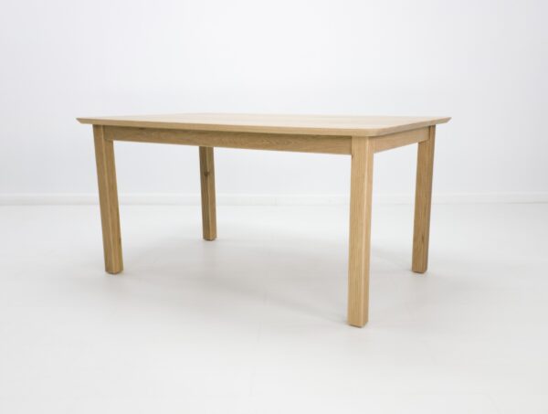 A ribbed leg dining table in white oak.