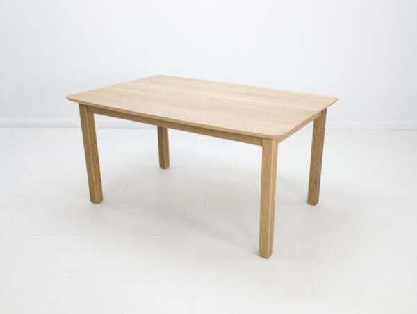 A ribbed leg dining table in white oak.