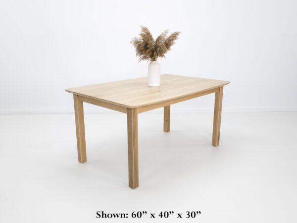A ribbed leg dining table with a vase on top.
