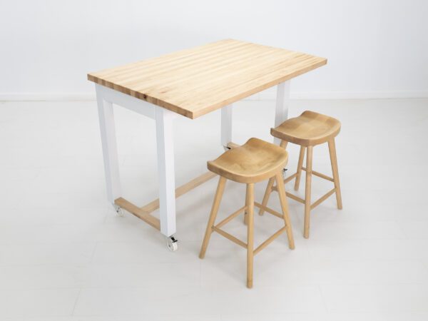 A butcher block kitchen island with seating.