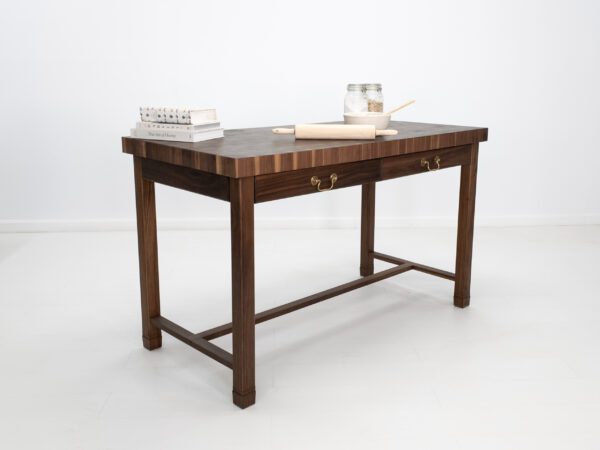 A butcher block kitchen island with decor on top of it.
