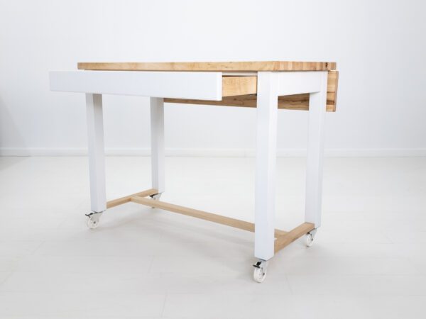 A butcher block kitchen island cart with room for seating a drawer open.