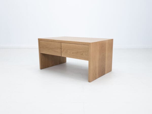 A continuous grain coffee table with drawers.